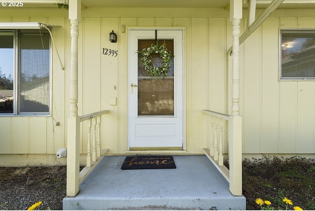 12395 SE Main St, Portland, OR 97233 - view of exterior entry featuring board and batten siding and a porch