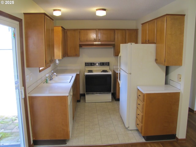 kitchen featuring white appliances and sink