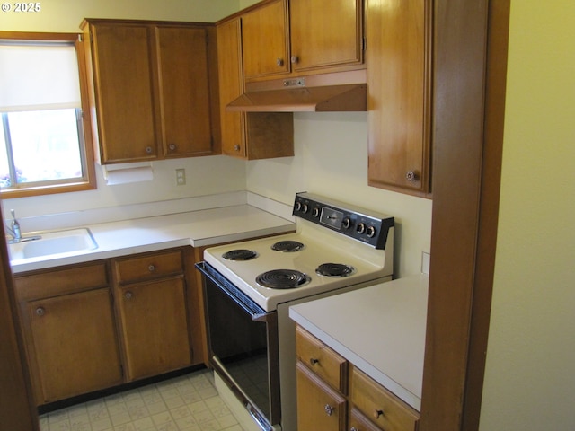 kitchen featuring white range with electric stovetop and sink