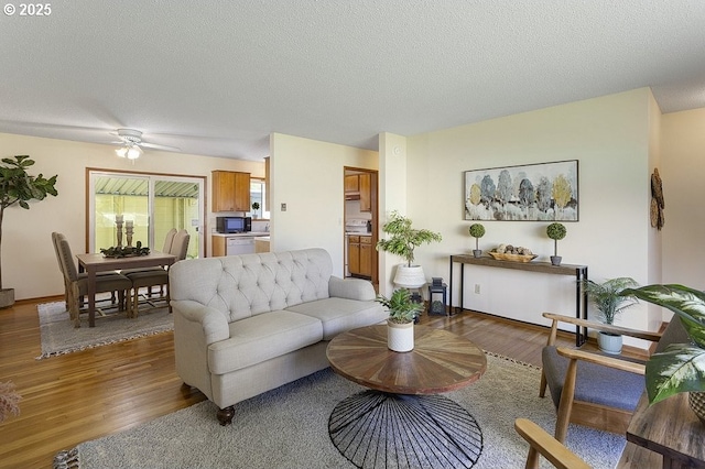 12395 SE Main St, Portland, OR 97233 - living room with wood finished floors, a ceiling fan, and a textured ceiling