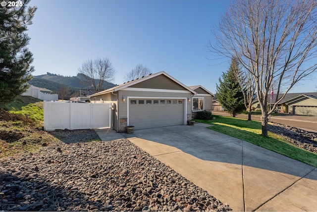 ranch-style house featuring a garage and a mountain view