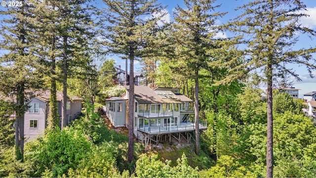 rear view of property with a shingled roof