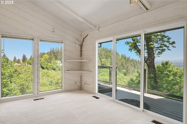 unfurnished sunroom with beam ceiling