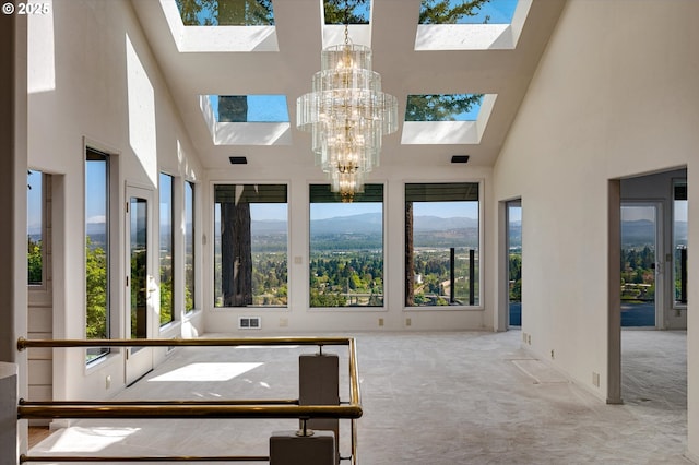 unfurnished sunroom with a skylight and a chandelier