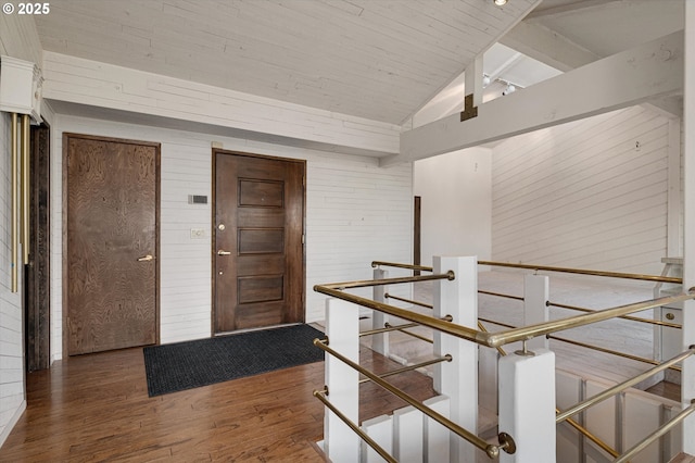 hall featuring an upstairs landing, vaulted ceiling, wood finished floors, wood ceiling, and wooden walls