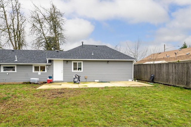 rear view of house with a patio area and a lawn