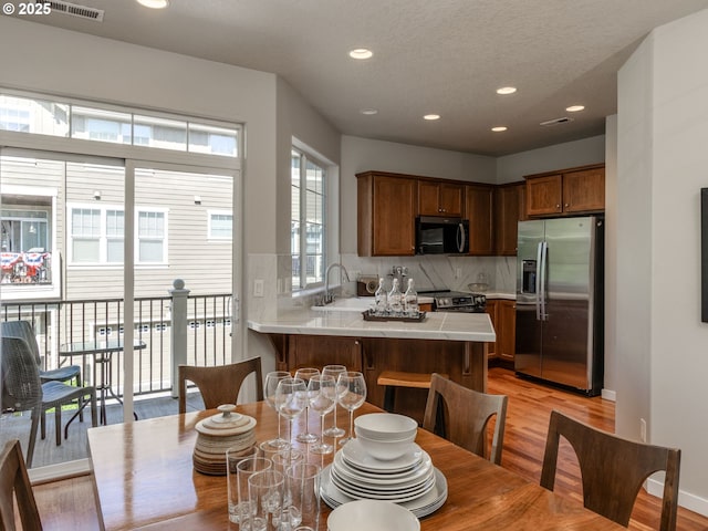 11656 SW Auklet Loop, Beaverton, OR 97007 - dining area with light wood-style floors and recessed lighting