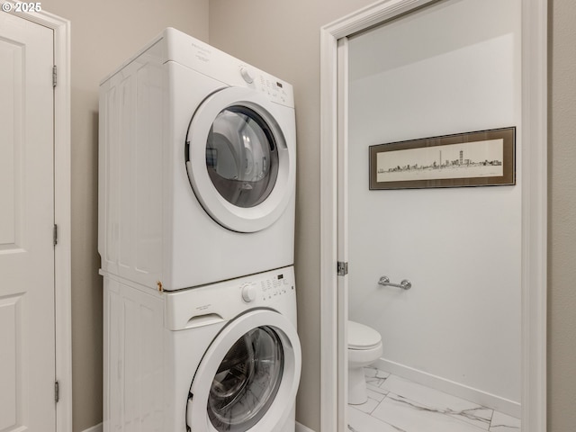 11656 SW Auklet Loop, Beaverton, OR 97007 - washroom featuring stacked washer / drying machine and marble look tiles