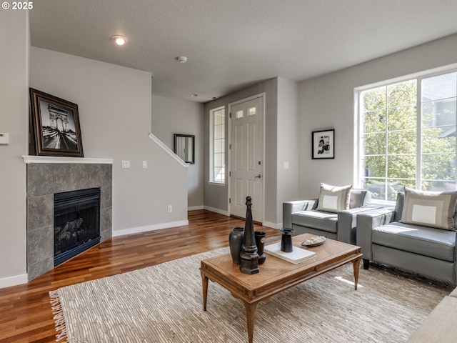 11656 SW Auklet Loop, Beaverton, OR 97007 - living area featuring wood finished floors and a tiled fireplace