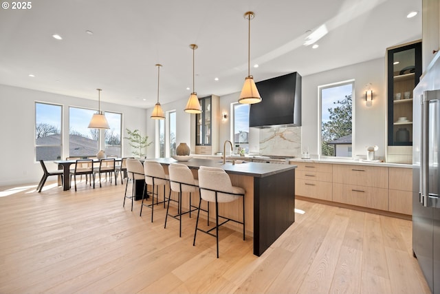 5100 S St, Washougal, WA 98671 - kitchen featuring decorative backsplash, light brown cabinetry, a large island, modern cabinets, and wall chimney exhaust hood