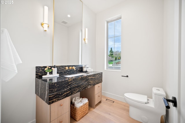 5100 S St, Washougal, WA 98671 - bathroom with visible vents, vanity, wood finished floors, toilet, and baseboards
