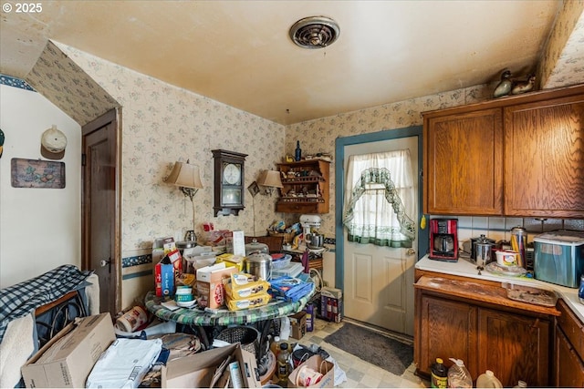270 SW 173rd Ave, Beaverton, OR 97006 - kitchen with wallpapered walls, light countertops, and brown cabinets