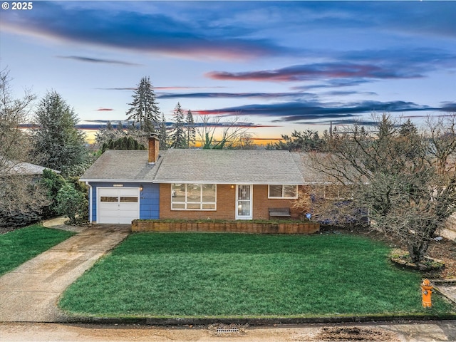 ranch-style house featuring a yard and a garage