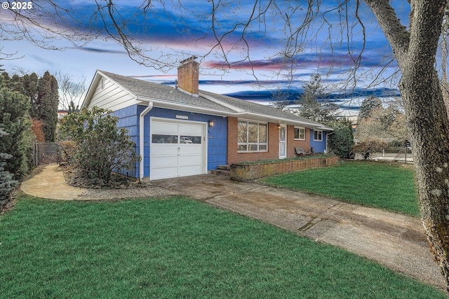 ranch-style home with a garage and a lawn