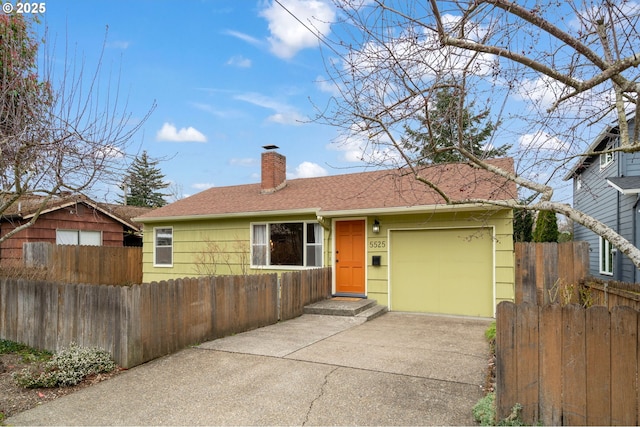 single story home with driveway, a fenced front yard, roof with shingles, a garage, and a chimney