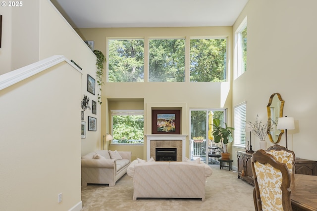 15760 SW Peachtree Dr, Portland, OR 97224 - living room featuring a towering ceiling, a tile fireplace, and light colored carpet