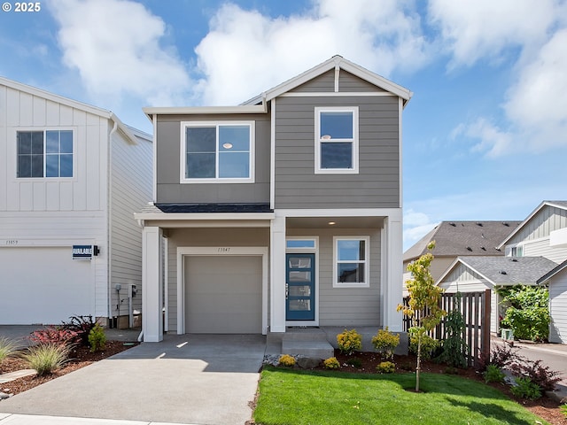 13847 SW Sabrina Ave, Tigard, OR 97140 - view of front of house featuring concrete driveway, a garage, a front yard, and board and batten siding