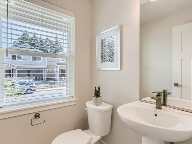 half bathroom with toilet and a sink