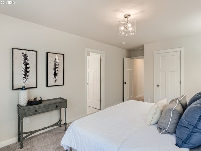 bedroom with light colored carpet and a chandelier