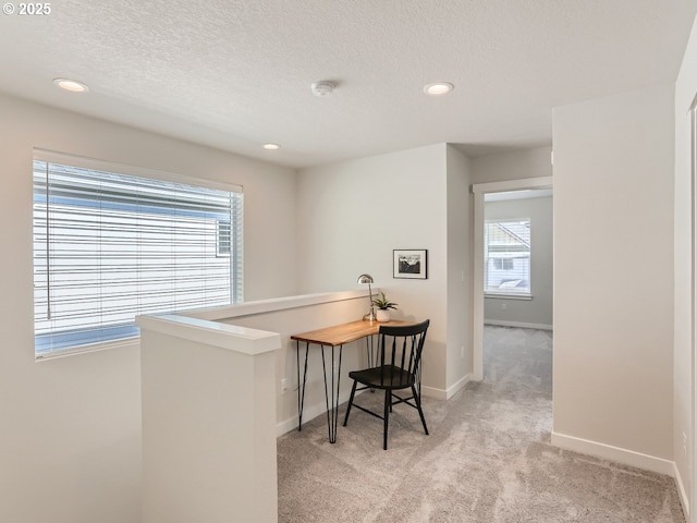 office featuring recessed lighting, light carpet, a textured ceiling, and baseboards