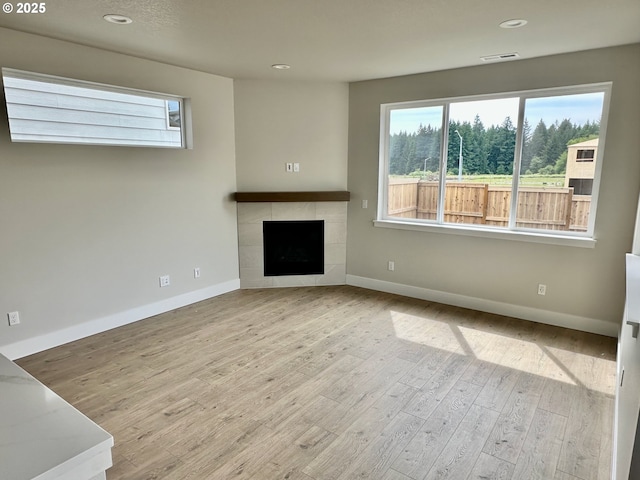 13847 SW Sabrina Ave, Tigard, OR 97140 - unfurnished living room featuring baseboards, healthy amount of natural light, wood finished floors, and recessed lighting