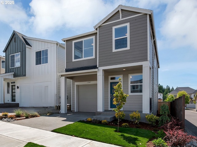 13847 SW Sabrina Ave, Tigard, OR 97140 - view of front of house featuring board and batten siding, a garage, and driveway
