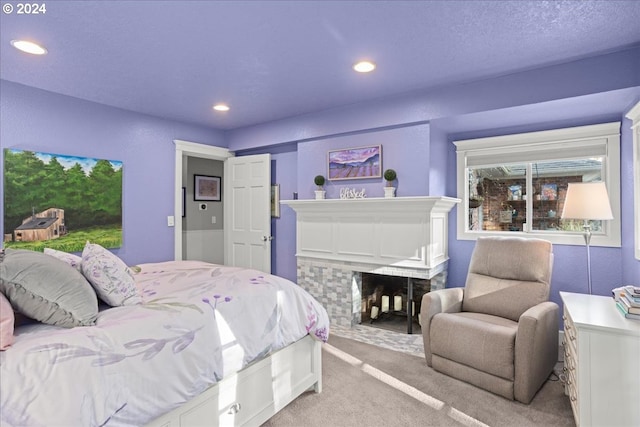 bedroom featuring recessed lighting, a fireplace, and light colored carpet