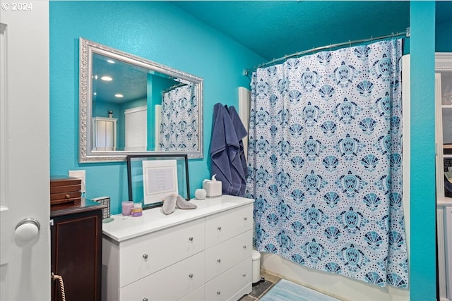 bathroom with shower / bath combo and vanity