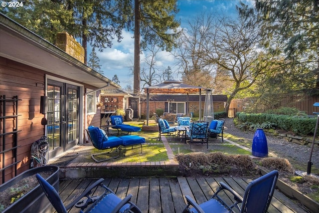 deck featuring a gazebo, fence, outdoor lounge area, and french doors