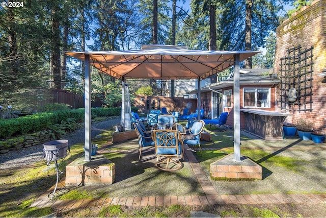 view of yard featuring a gazebo, outdoor lounge area, and fence