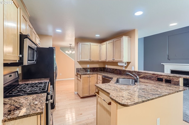 10793 SW Canterbury Ln Unit 101, Portland, OR 97224 - kitchen with appliances with stainless steel finishes, a peninsula, light wood finished floors, recessed lighting, and stone counters