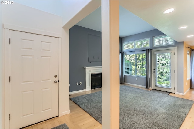 10793 SW Canterbury Ln Unit 101, Portland, OR 97224 - entrance foyer with light wood-style flooring, a fireplace, and recessed lighting