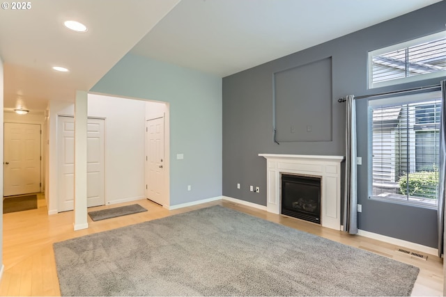 10793 SW Canterbury Ln Unit 101, Portland, OR 97224 - unfurnished living room featuring light wood-style floors, a fireplace, and recessed lighting