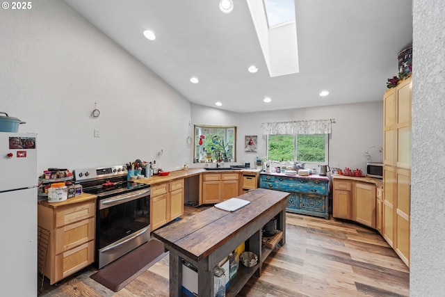 kitchen featuring light wood-style floors, recessed lighting, light brown cabinets, and stainless steel appliances