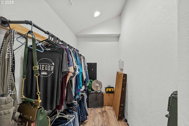 spacious closet with wood-type flooring and vaulted ceiling