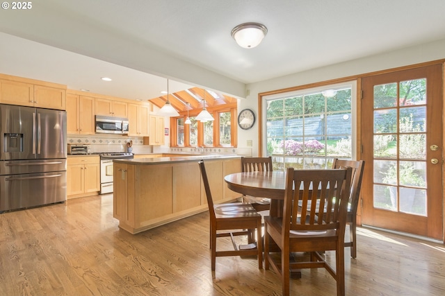 dining space with recessed lighting and light wood finished floors