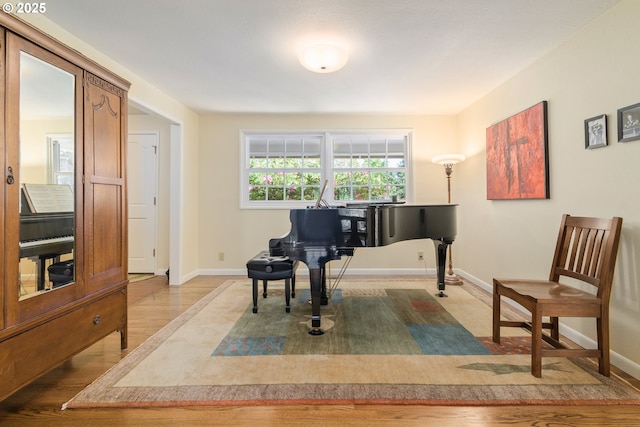 sitting room featuring baseboards and light wood-style flooring