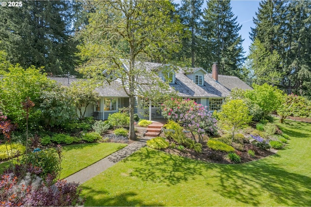 view of front of property with a chimney and a front yard