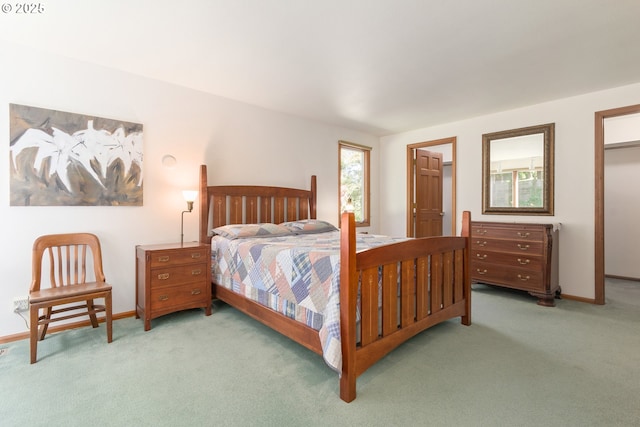 carpeted bedroom featuring baseboards