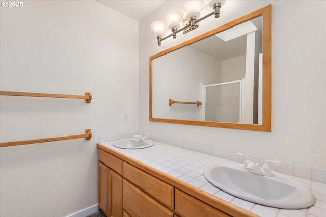 bathroom featuring walk in shower and vanity