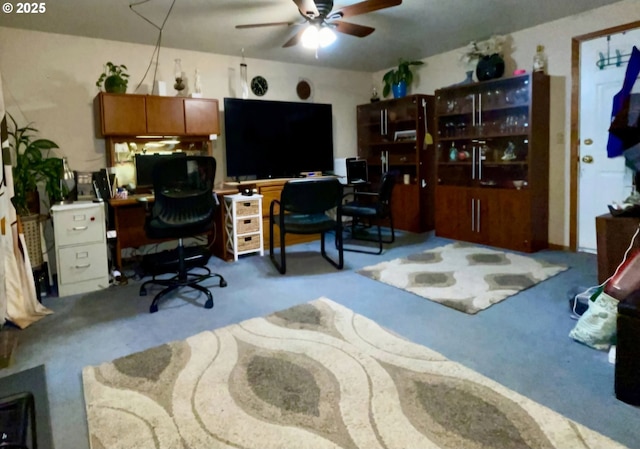 carpeted office space with a ceiling fan