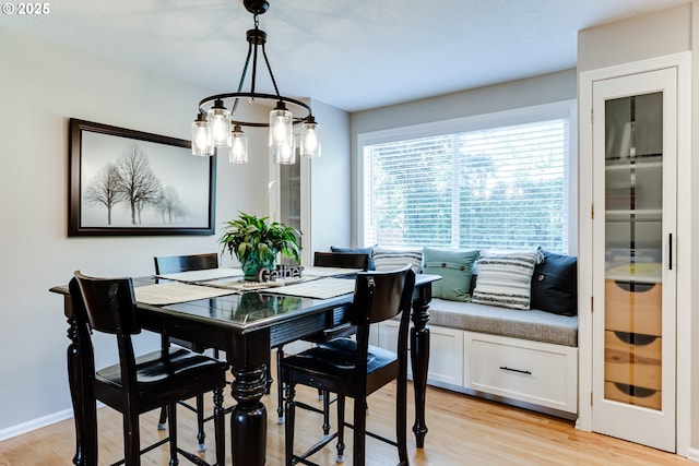 dining space with a notable chandelier and light wood-type flooring