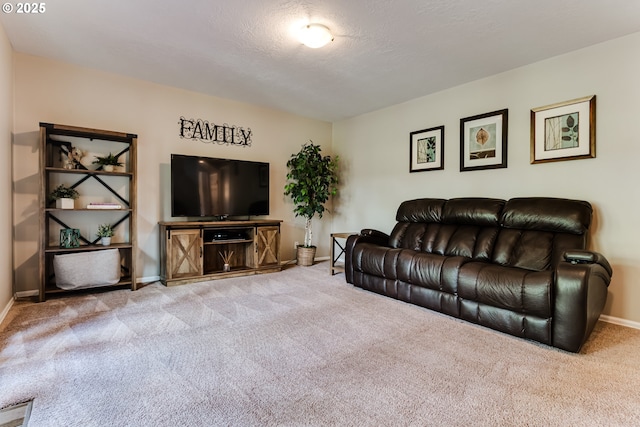carpeted living area with baseboards