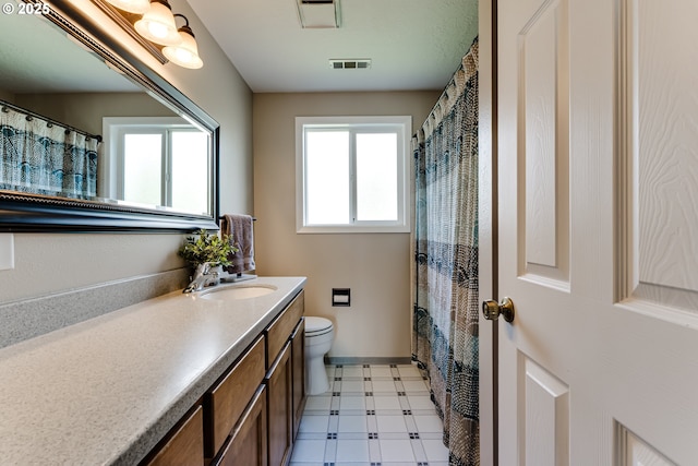bathroom with visible vents, tile patterned floors, toilet, and vanity