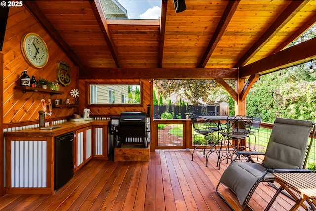 wooden terrace with fence and outdoor dining area