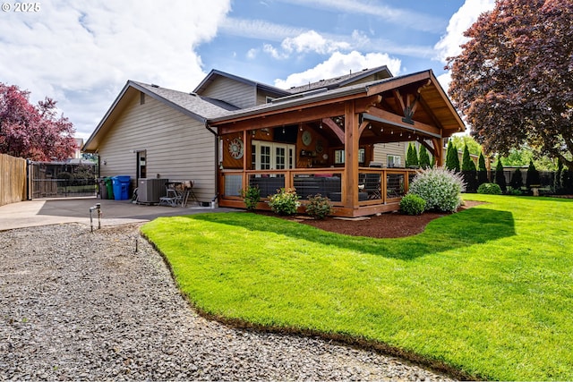 back of house featuring fence, french doors, a deck, cooling unit, and a lawn