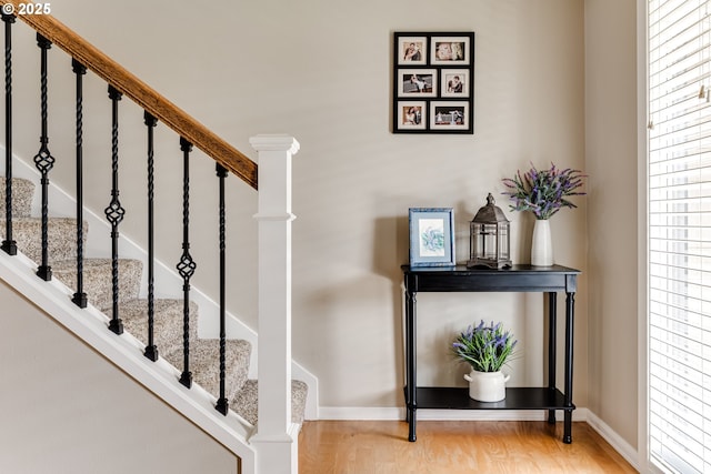 stairs featuring baseboards and wood finished floors