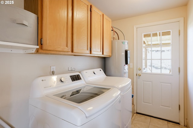 8095 SW High Cone Dr, Terrebonne, OR 97760 - laundry area with water heater, washing machine and clothes dryer, light tile patterned flooring, and cabinet space