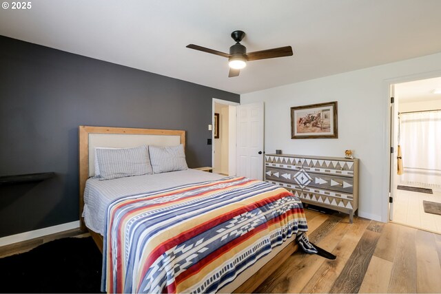 8095 SW High Cone Dr, Terrebonne, OR 97760 - bedroom with wood finished floors, connected bathroom, ceiling fan, and baseboards