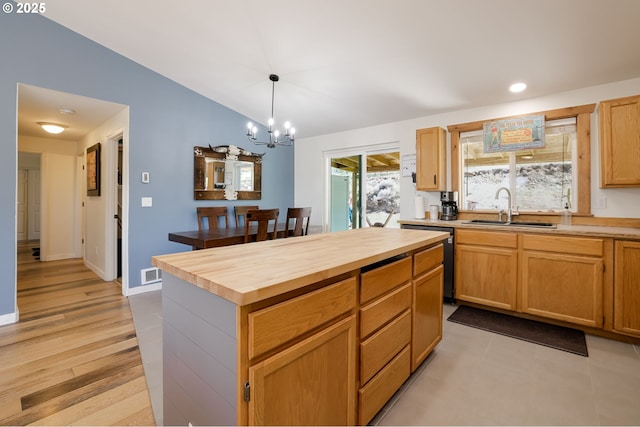 8095 SW High Cone Dr, Terrebonne, OR 97760 - kitchen featuring a sink, butcher block countertops, black dishwasher, a chandelier, and vaulted ceiling
